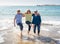 Group of three senior women walking having having fun on beach. Friendship and retirement lifestyle