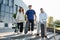 Group of three skaters posing together outdoors in city