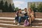 Group of three students sitting on stairs