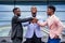 A group of three stylish African American businessman friends entrepreneurs fashion business suits meeting handshaking