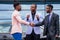 A group of three stylish African American businessman friends entrepreneurs fashion business suits meeting handshaking