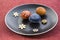 Group of three wax painted Easter eggs spread on black plate, flower ornaments, traditional decoration