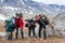 Group of tired climbers stand shoulder to shoulder, portrait of senior couple, teenage boy and adult man, people dressing