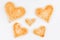 Group of toasted bread hearts with one broken heart together on white background