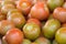 Group of tomatoes in market place. Red round ripe background. Ketchup production