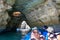 A group of tourist in a boat visiting the caves of Benagil