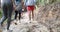 Group Of Tourist In Forest Back Rear View Of People Trekking Path In Woods Holding Backpacks On Hike