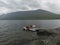 Group of tourist hikers on motor boat at pier prepar to crossing Teusajaure lake at Kungsleden hiking trail. Lapland mountains