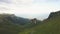 Group of tourist people hiking in green mountain aerial landscape