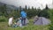 Group of tourist people spend summer vacations in camping at mountain