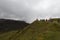 A group of tourist at the top of a grass badland mountain watching and taking pictures at palace quarry viewpoint