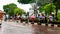 Group of tourist walking at the side of the main road with their colorful umbrella during the rainy days in Melaka