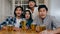 Group of tourist young Asia friend watching football in sports TV, drink alcohol beer and having hangout party in night club at