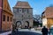 Group of tourists admiring the colorful medieval streets, Tailors tower in the background.