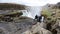 Group of tourists admiring the stunning waterfall of Gullfoss in the Golden Circle