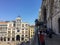 A group of tourists on the balcony of saint marks basilica beside the horses of saint mark, taking photos and admiring the views