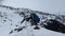 A group of tourists climb the mountain through the snow in the fog. Trekking in the mountains in winter.