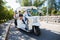 A group of tourists driving through the city center in tuk-tuk electric car. Travelers enjoying a ride