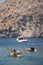 A group of tourists on excursions, kayak rental and sightseeing guide. Active leisure and sport. Back view. Vertical photo. Cliffs