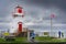 A group of tourists exploring a historic lighthouse and popular local attraction along the Canadian East Coast.