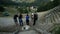 Group of tourists feeding deers with corn