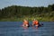 A group of tourists floating on a quiet river on inflatable catamarans, outdoor activities