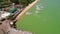 Group of tourists goes to speedboat. Chalong pier water transport aerial look around. HD. Phuket, Thailand.