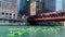 Group of tourists in kayaks paddle across the Chicago River near the Merchandise Mart