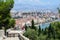 A group of tourists and locals admiring the beautiful faraway view of Split, Croatia from Marjan Hill on a sunny summer day.