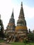 A group of tourists are photographed under two stupas in Ayutthaya, the former capital of the kingdom of Siam. Thailand