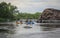 A group of tourists rafting on catamarans along the river with rocky shores. Rafting on the
