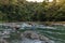 group of tourists rafting on a raft in the middle of the jungle on the Pacuare River in Costa Rica