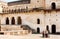 Group of tourists standing inside courtyard of ancient structure of Jahangir Mahal in India