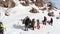 A group of tourists stopped at the stone and discusses where to move on, gesturing with his hands. aerial