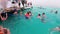 Group of tourists swims in the Red Sea near pleasure boats. Snorkeling in the open sea.