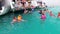 Group of tourists swims in the Red Sea near pleasure boats. Snorkeling in the open sea.