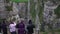 Group of tourists taking photos, enjoying view of large rock canyon, sightseeing