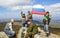 A group of tourists at the top of the mountain Yalangas in the southern Urals with the Russian national flag