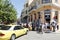 A group of tourists walking around the city along the shops