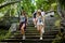 Group of tourists walking down steps of ancient ruins in thailand