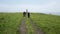 A group of tourists walks along a beautiful hillside