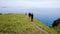A group of tourists walks along a beautiful hillside