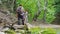 A group of tourists walks along the bottom of the canyon along a clean mountain river.