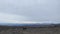 A group of tourists walks through the lava fields of central Kamchatka