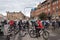 A group of tourists in white helmets cycling at the town halll square in Copenhagen