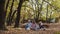 Group of tourists women ehjoying an autumn forest picnic in the sunny october day