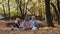 Group of tourists women ehjoying an autumn forest picnic in the sunny october day