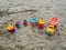 Group of toy working trucks on a sandy beach