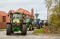 A group of tractors going through a village town