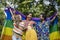 Group of transgender and homosexual people celebrating LGBTQ+ pride month in colorful dress and rainbow flag with positive vibe